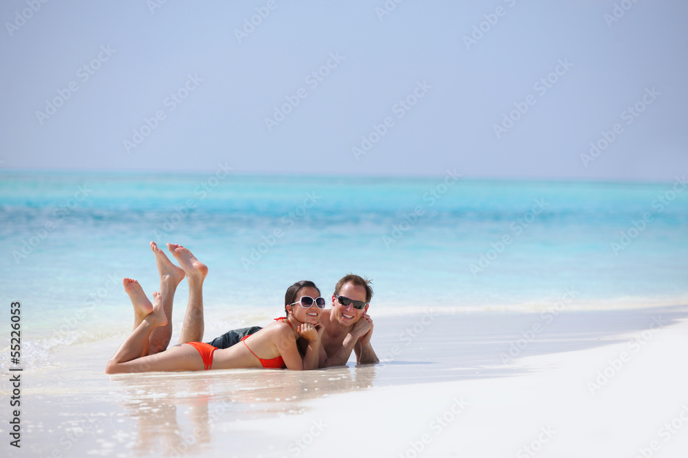 happy young couple have fun on beach