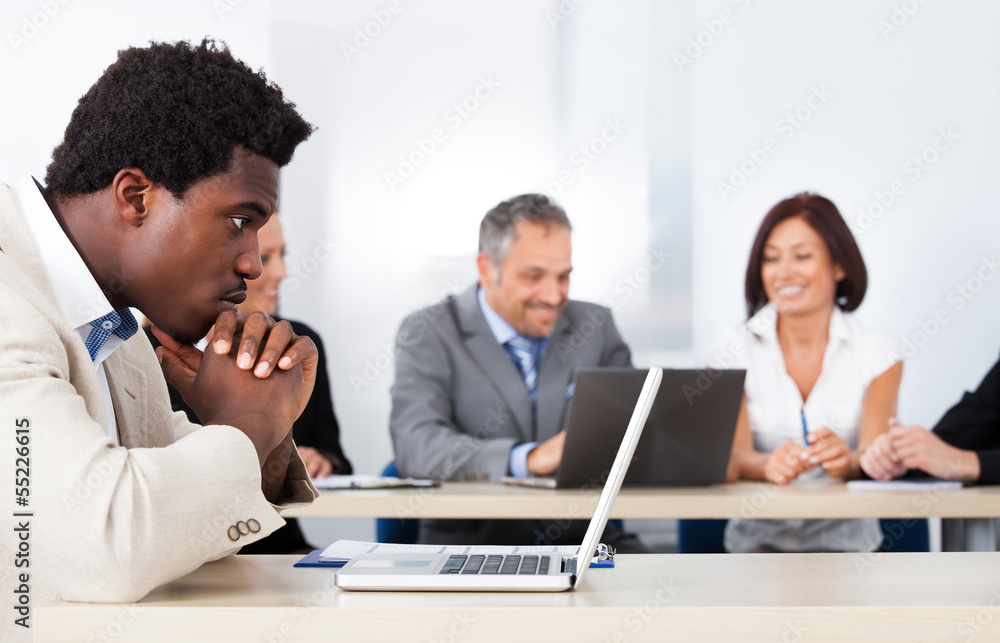 African Businessman Looking At Laptop African Businessman Looking At Laptop