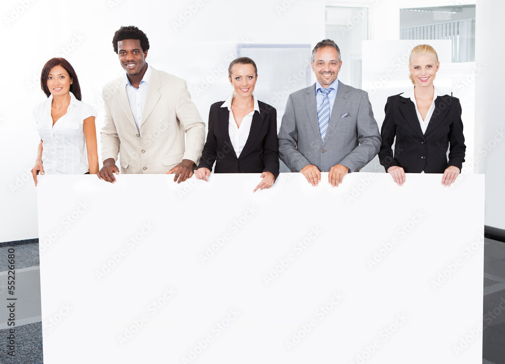 Multiracial Businesspeople Holding Placard Multiracial Businesspeople Holding Placard