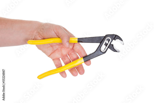 Hand Holding Pliers With Yellow Grips