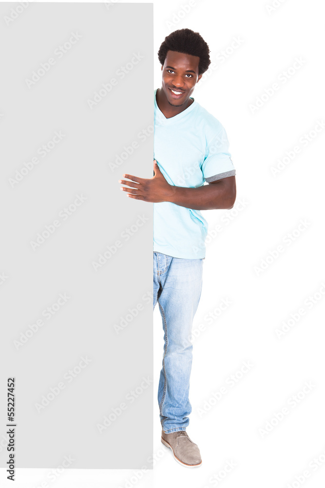 Young Man Standing Behind The Placard Young Man Standing Behind The Placard