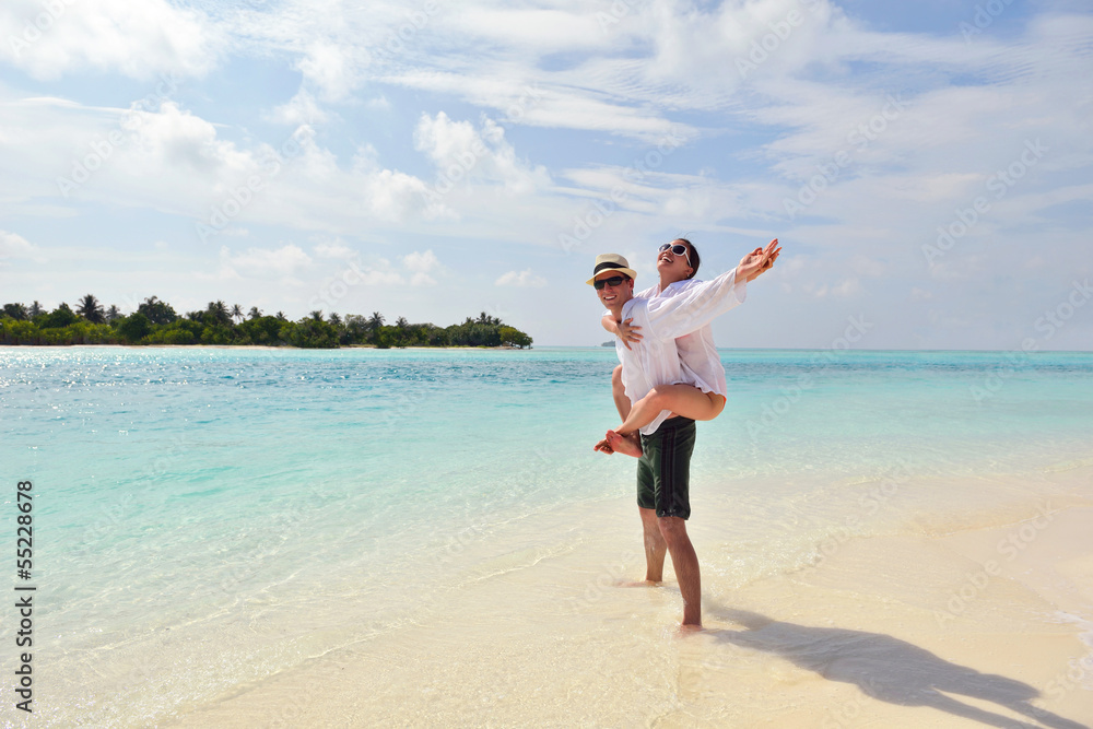 happy young couple have fun on beach