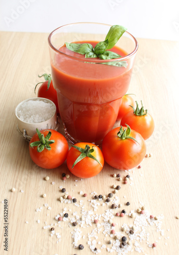 tomato juice in a glass on a wooden surface