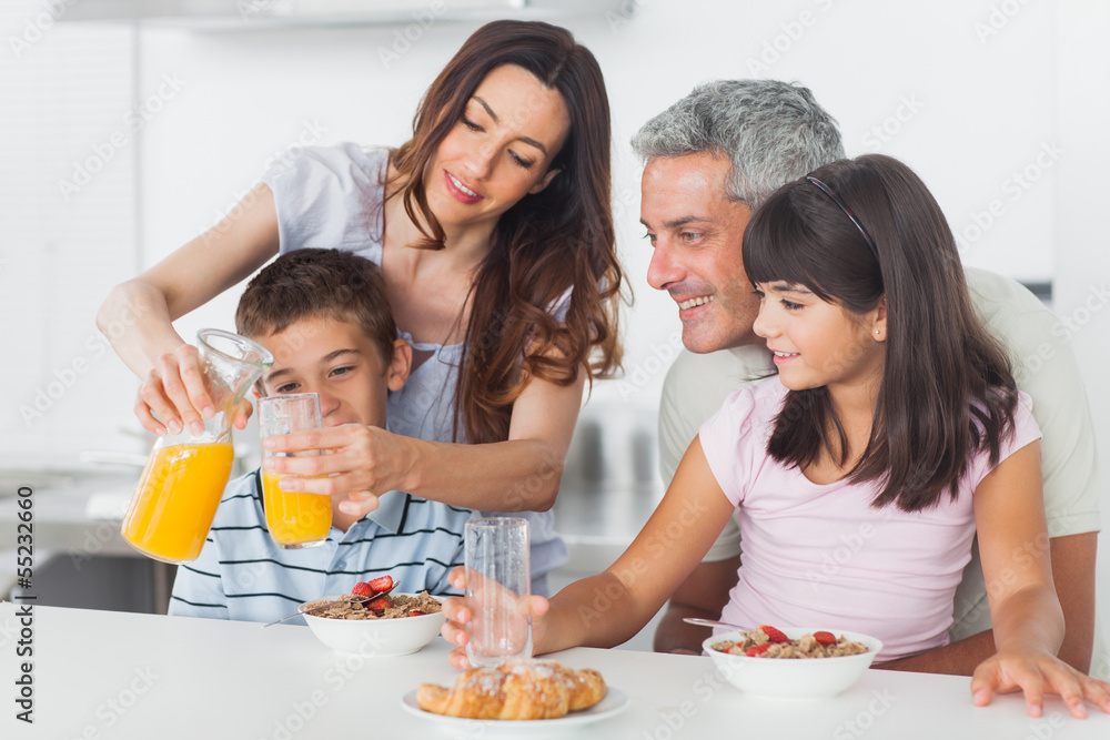 Family eating breakfast in kitchen together