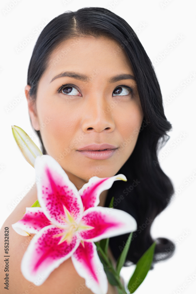 Thoughtful natural model posing with lily Thoughtful natural model posing with lily