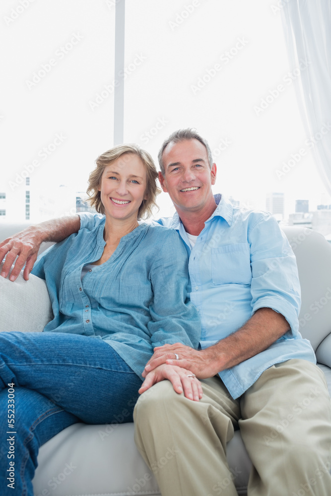Middle aged couple sitting on the couch Middle aged couple sitting on the couch