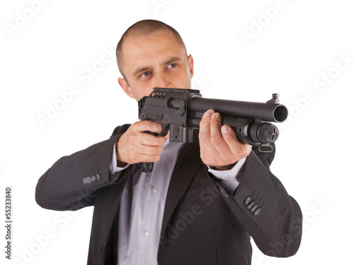 Mafia man is holding a shotgun