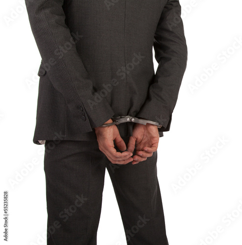 Businessman in suit and handcuffs