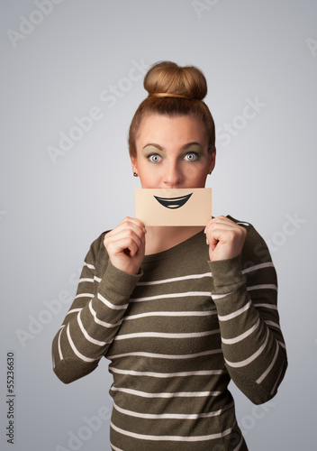 Happy pretty woman holding card with funny smiley