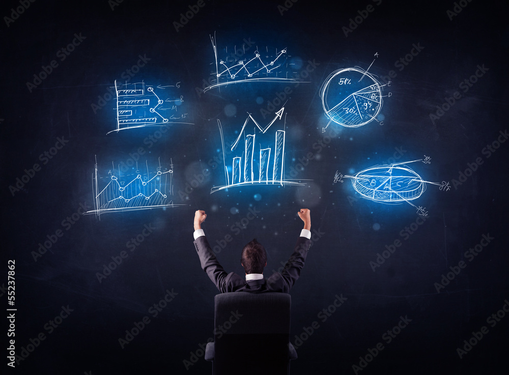 Businessman in chair looking at charts Businessman in chair looking at charts