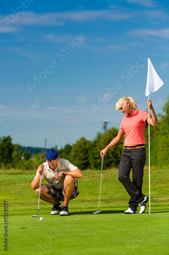 Принти на полотні Young sportive couple playing golf on a course