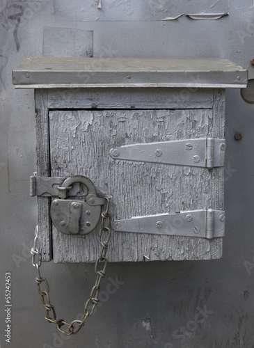 Old mystery wooden box locked with padlock