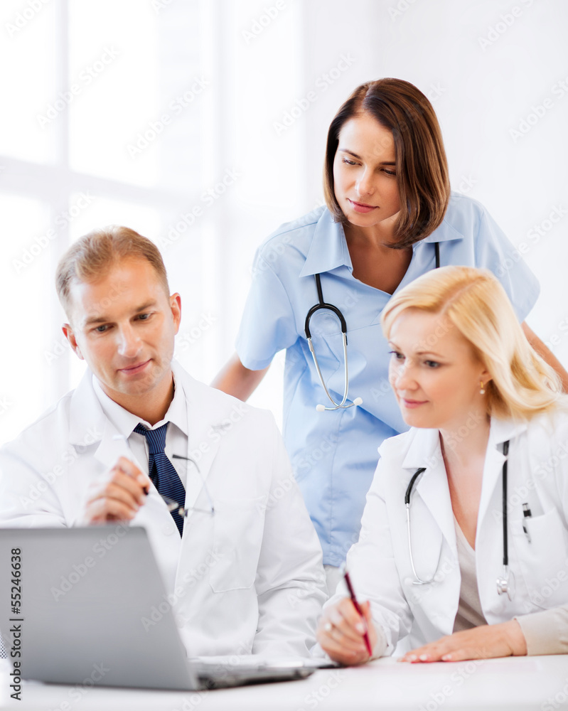 doctors looking at laptop on meeting doctors looking at laptop on meeting