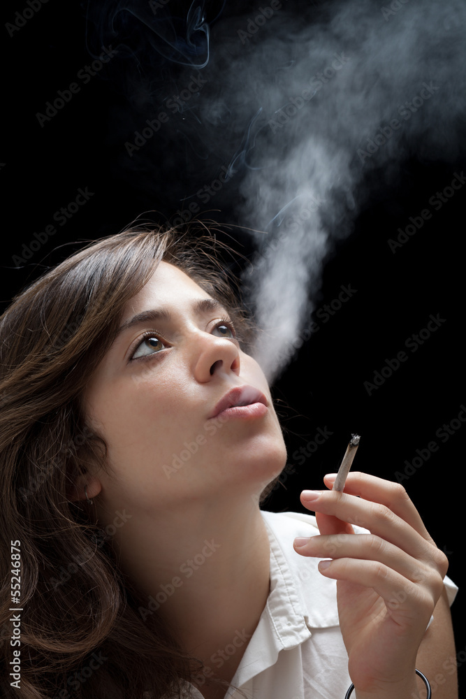 Obraz premium Woman Smoking a Cigarette on Black Background