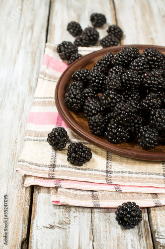ripe blackberries in a clay bowl