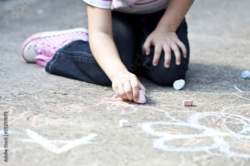 Back to school concept girl drawing with chalk