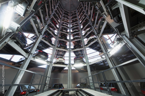 Several levels of platforms arranged in circle with cars photo