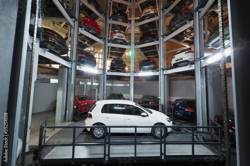 white car on parking lot with automated car parking system