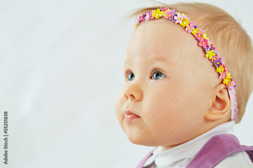 Little girl with headband in form of chaplet on her head Little girl with headband in form of chaplet on her head