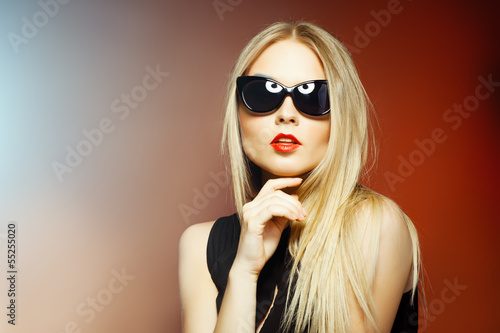 Fashion woman in sunglasses, studio shot. Professional makeup