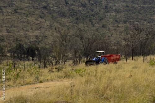 Black farmer in a tractor working in the fields in South Africa