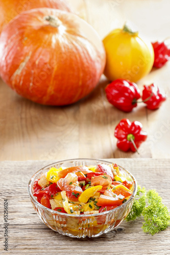 Fresh colorful vegetable salad in transparent glass bowl