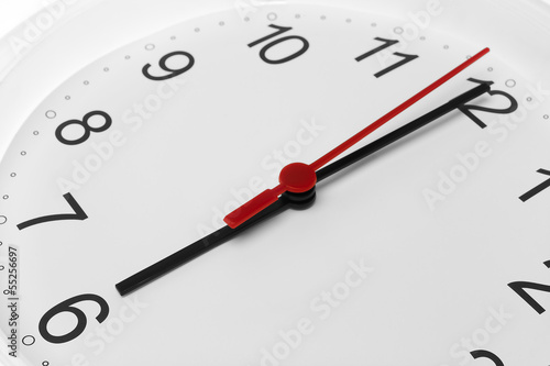 Clock face showing time running to six on white background