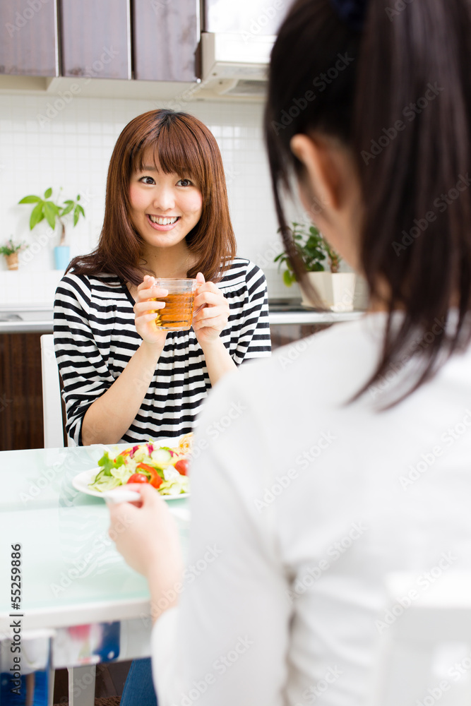beautiful asian women eating in the kitchen beautiful asian women eating in the kitchen