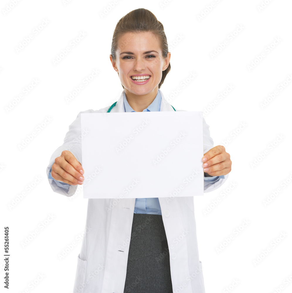 Smiling doctor woman showing blank paper sheet Smiling doctor woman showing blank paper sheet