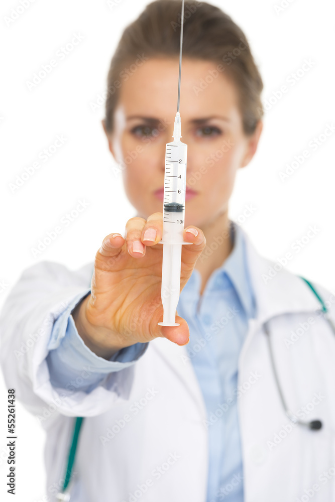 Closeup on syringe in hand of doctor woman Closeup on syringe in hand of doctor woman