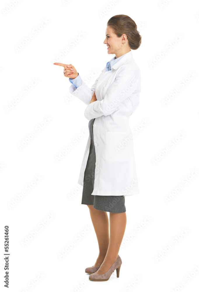 Full length portrait of doctor woman pointing on copy space Full length portrait of doctor woman pointing on copy space