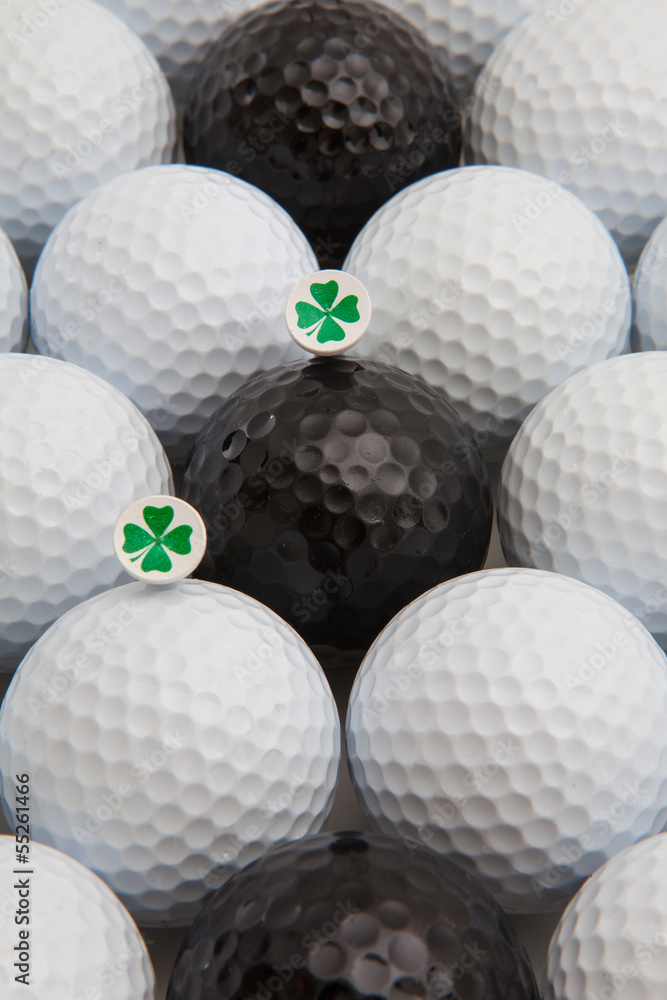 White and black golf balls and wooden tees White and black golf balls and wooden tees