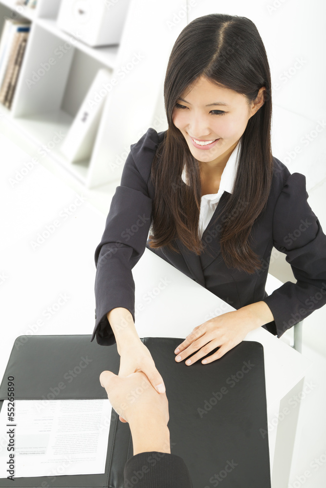 smiling businesswoman handshaking with businessman in the office smiling businesswoman handshaking with businessman in the office