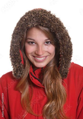 Smiling young woman in a red winter coat