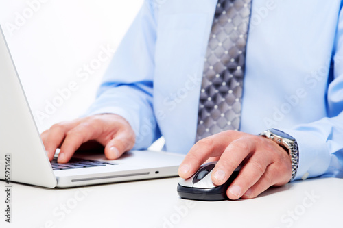 Hands of businessman with laptop.