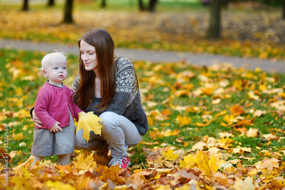 Young mother and her toddler daughter at fall Young mother and her toddler daughter at fall