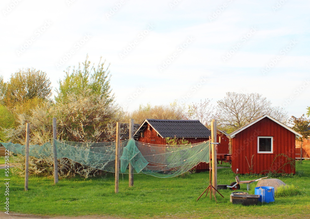 Red fishermens houses with net in foregound Red fishermens houses with net in foregound