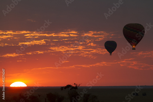 Balloons flying in early morning red sky