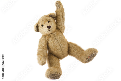 Old teddy bear isolated on white background