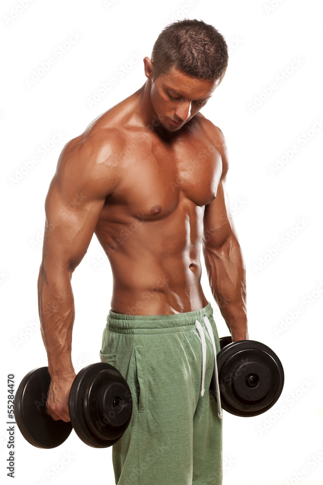 Muscular man holding weights and posing on a white background Muscular man holding weights and posing on a white background