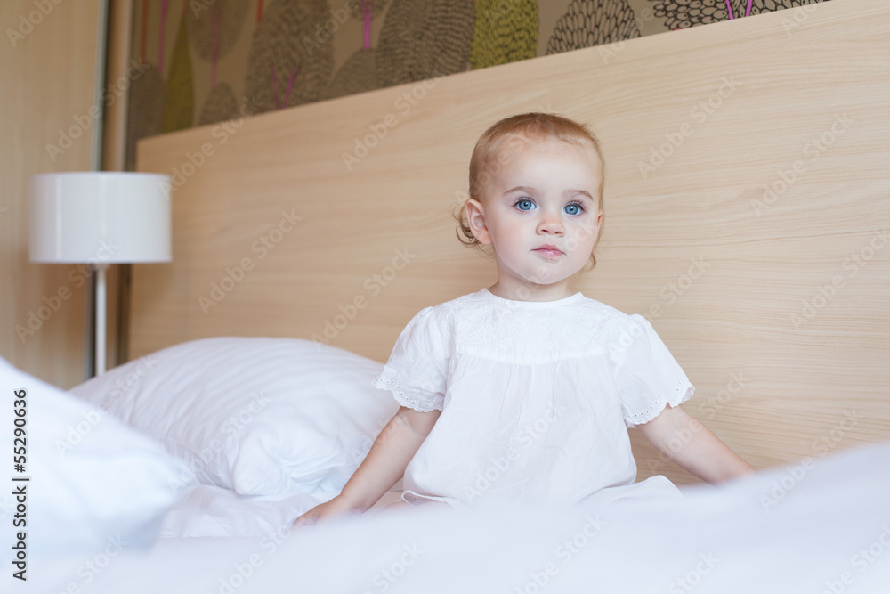 Beautiful baby sitting on the bed Beautiful baby sitting on the bed