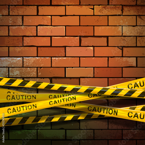 Caution ribbon on brick wall