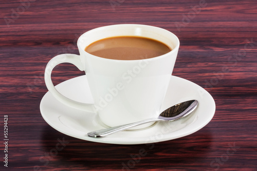 Coffee cup whit spoon on table