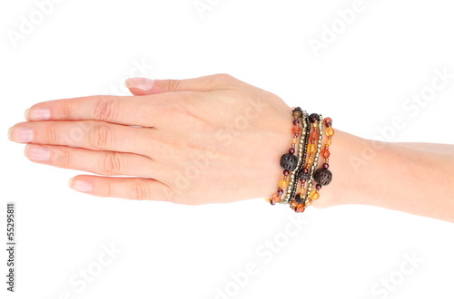 Hand of woman with bracelets on white background