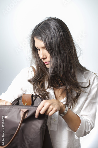 woman searching in handbag