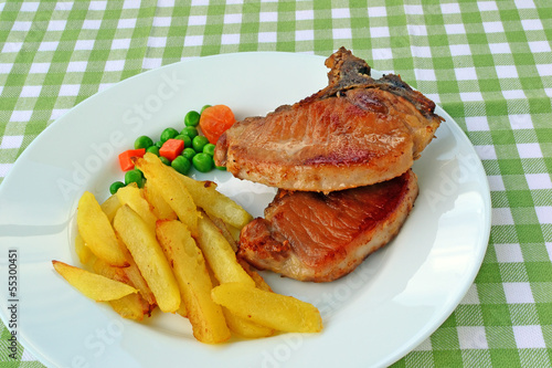 Pan-fried pork steak with french fries.