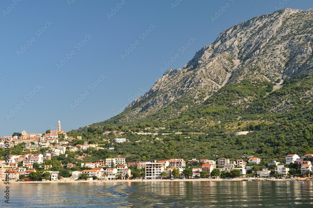 Village of Igrane with tower, adriatic sea and mountain Biokovo