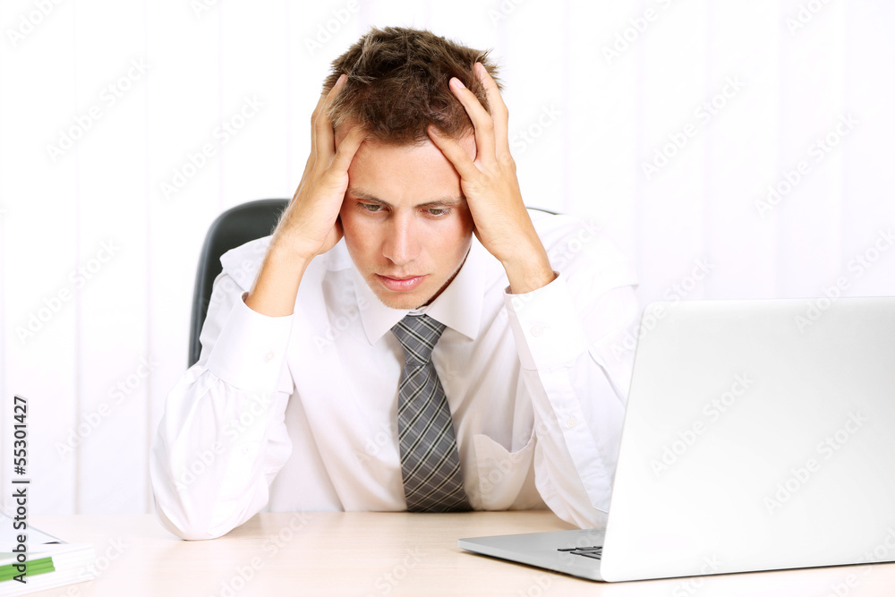 Portrait of young businessman working in office Portrait of young businessman working in office
