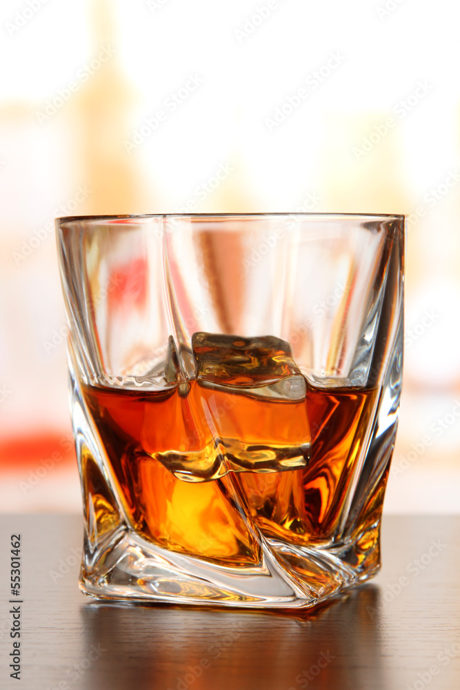 Glass of whiskey, on bright background