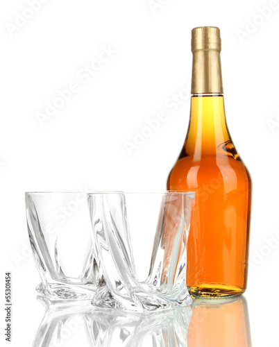 Glasses of whiskey with bottle, isolated on white